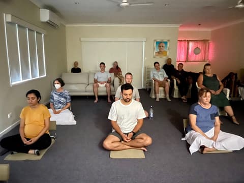 Meditating on cushions in a class