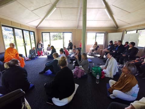 A monk answering questions in the meditation hall